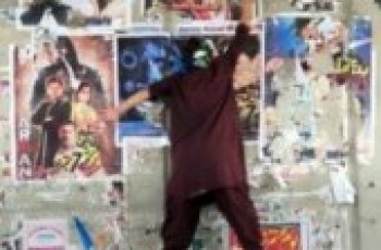 JI workers tearing film posters