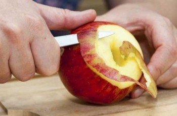 man peeling an apple