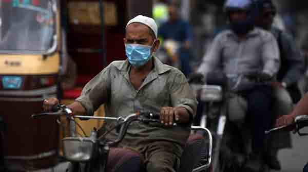 man wearning mask riding motorcycle