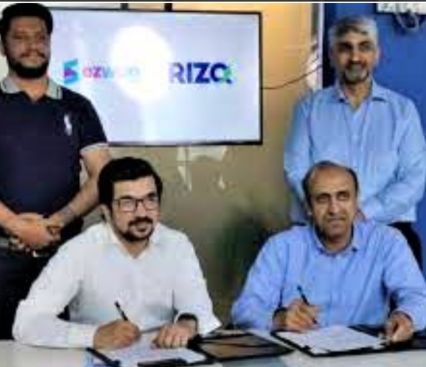 RIZQ and EZ Wage employees signing a MOU