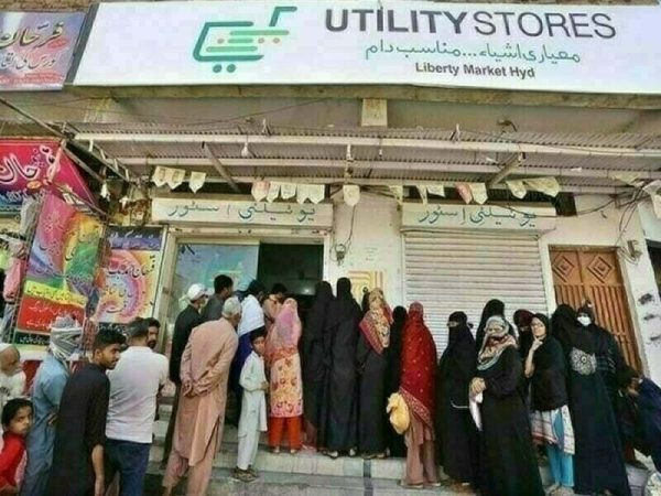 People standing outside a Utility STore