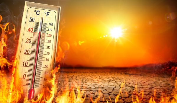 A picture of hot weather with sun in the background and a thermometer engulfed in flames